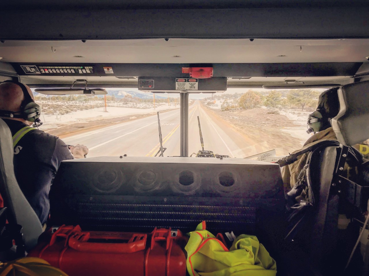Two firefighters riding in a fire engine